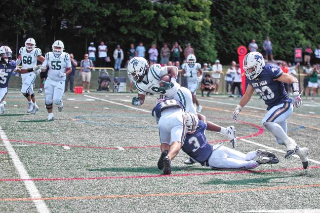 <b>Pope John defenders tackle a DePaul ball carrier. (Photo by George Leroy Hunter)</b>