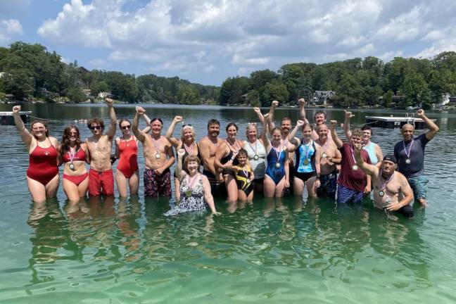 Participants in the Lindy’s Lake Distance Swim pose for a photo after the event Sunday, Aug. 6. (Photo by John Caggiano)