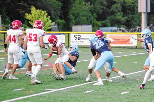<b>A Lakeland ball carrier is taken down by a Sparta tackler.</b>
