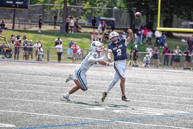 <b>Pope John quarterback Luke Irwin (2) throws the ball while being chased by DePaul defender Jaxon Bastante. (Photo by George Leroy Hunter)</b>