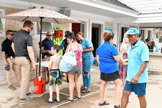 Residents line up for ice cream sandwiches during the Ice Cream with a Cop event Tuesday, July 15 at the Newton town pool. (Photos by Maria Kovic)