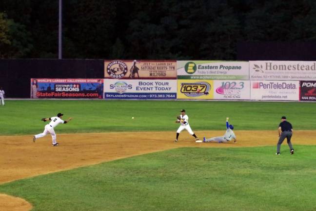 PHOTOS BY GEORGE LEROY HUNTER In the second inning Sussex County Miners infielder Chris Chiaradio tosses the ball to second baseman Steve Nyisztor as Rockland Boulders runner Mike Fransoso slides.