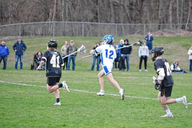 Kittatinny's Shane Carman (12) carries the ball with his lacrosse stick. He is credited with scooping up three ground balls.