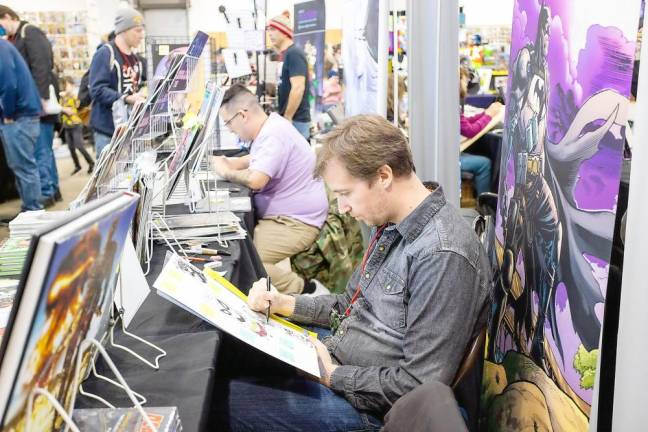 Comic book artist and writer Reilly Brown draws during the event.