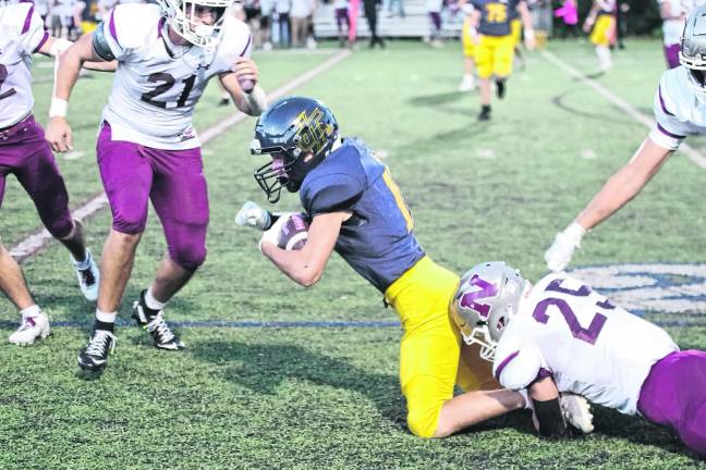 Jefferson wideout Blake Glamann is tackled by Newton linebacker Brayden Alpaugh.