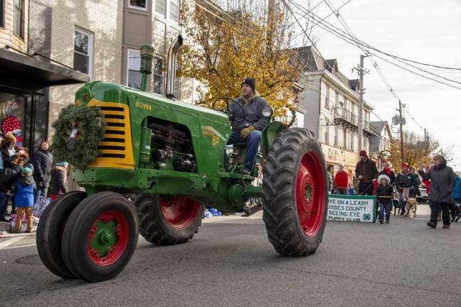 A tractor precedes members of the Sussex County chapter of the Seeing Eye.