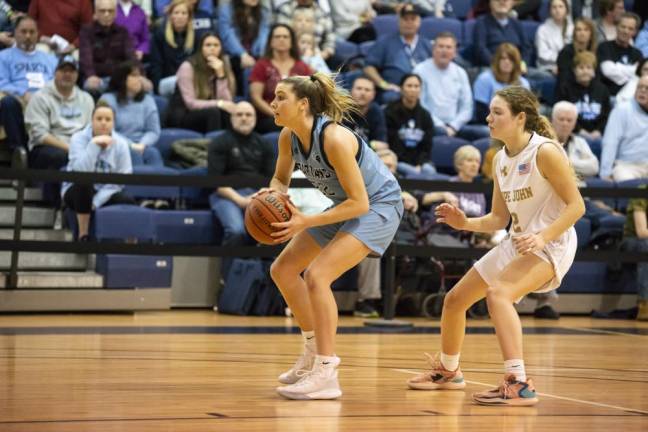 Sparta's Bailey Chapman looks to pass the ball as Pope John's Kylie Squier closes in. Bailey, with 12 points, three assists and two steals, was named the Most Valuable Player in the finals.