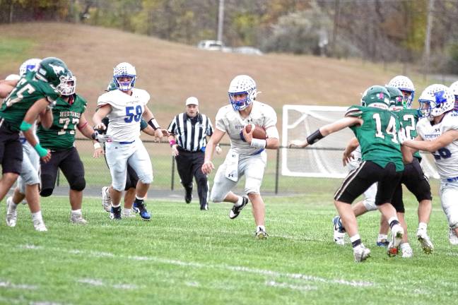 <b>Kittatinny quarterback Jack Brex carries the ball. He threw two touchdown passes.</b>