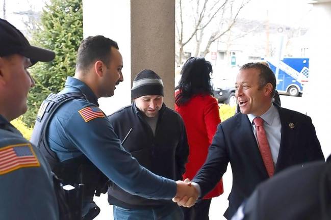 Rep. Josh Gottheimer shakes hands with a local police officer.