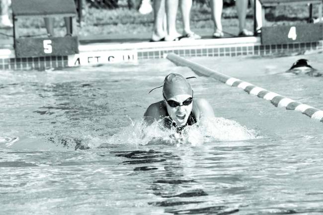 Kayla Brown, 16, won the second heat of the 100-yard individual medley.