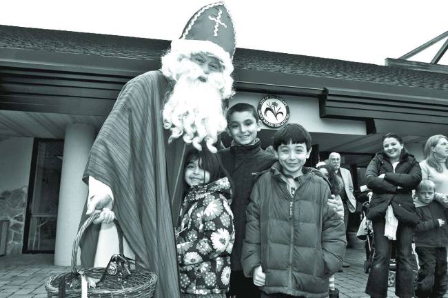 Saint Nicholas with Cecelia Maione, 6, brother John, 9, and brother Billy, 7, of Sparta.