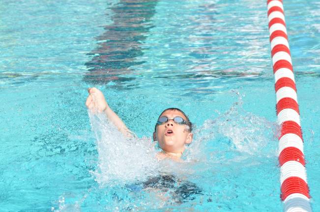 Thomas McGuire, 14, won the first heat in the 50-yard backstroke.