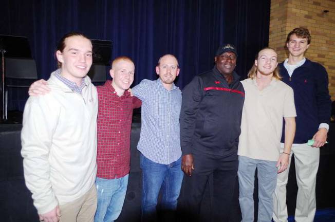 Anderson poses with several current and past Pope John athletes. From left, Joseph McCrimlisk, Brendan Pezzulo, boys volleyball coach Brian Vohden, Rich Peterson and Andrew Ward.