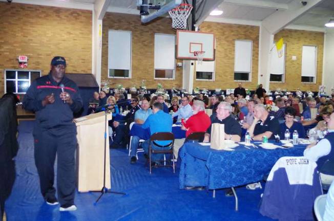 Football legend O.J. Anderson speaks in front of guests.