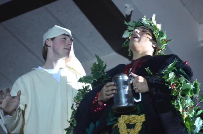 Senior Hunter Gallo, left, and sophomore Adam Nieves act out scene during rehearsal of the Pope John Players’ production of “A Christmas Carol” on Monday at Pope John XXIII Regional High School. In the show, Gallo plays the role of Ebenezer Scrooge, while Nieves plays the role of the Ghost of Christmas Past.