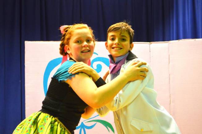 Hannah Peterson (left) plays the role of Princess Anna, and Cooper Randall, plays the role of Prince Hans of the Southern Isles, perform a scene during rehearsal of Pope John XXIII Middle school’s presentation of Disney’s “Frozen JR.” on Monday at Reverend George A. Brown’s McKenna Hall.
