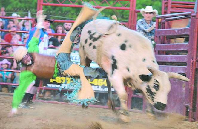 A well protected cowboy is thrown.