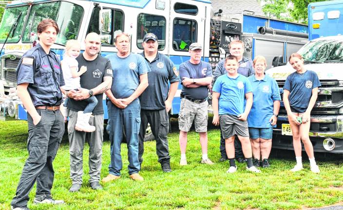 Hampton Township Fire &amp; Rescue pose bythe fire and rescue trucks.