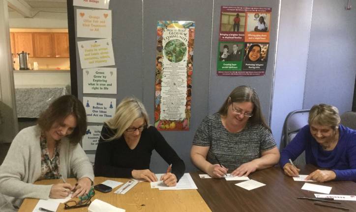 Unitarian Universalist Fellowship members write postcards to their senators.