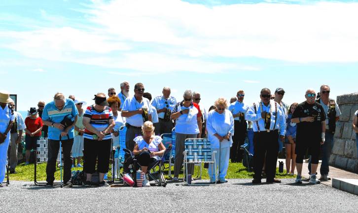 <b>Those attending the service bow their heads.</b>