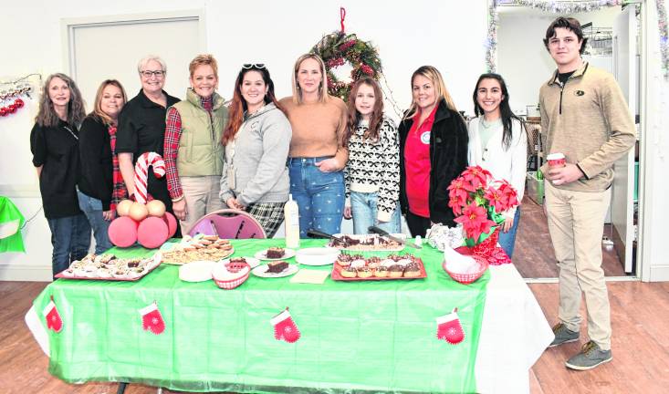 Members of the Townof Newton Recreation Dept. stand behind a dessert table.