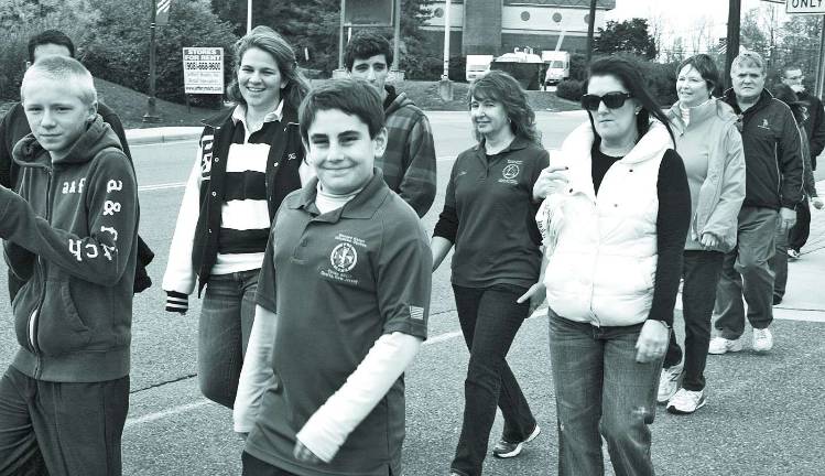 Squire co-captain Jack Lubertazzi leads Saint Kateri team down Sparta avenue in route to Station Park