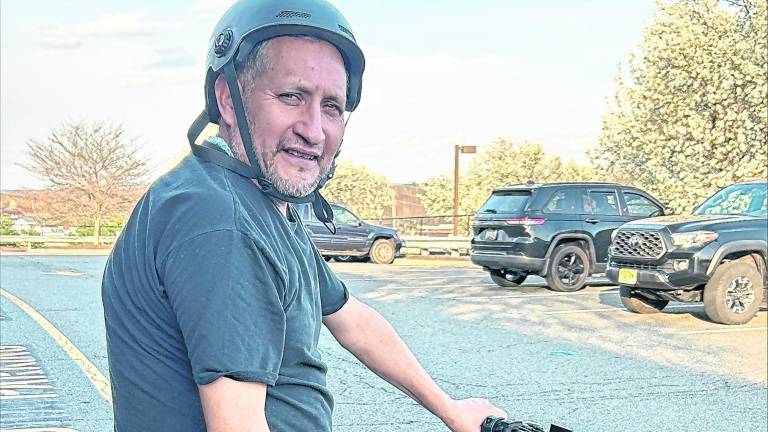 <b>Miguel Ceballos of Newton poses on his e-bike.</b>
