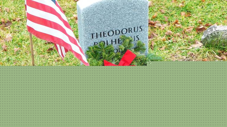 <b>The gravestone of Revolutionary War veteran Theodorus Polhemus in the Old Newton Cemetery is decorated as part of Wreaths Across America in December 2018. The gravestone was erected in October 2018 as part of a joint effort of the Daughters of the American Revolution, Sussex County Historical Society and Old Newton Cemetery Committee to locate and mark previously unmarked graves. Polhemus was born in Haverstraw, N.Y., and served as a corporal in the Orange County, N.Y., militia. He died in Newton in 1820. (Photo by Mandy Coriston)</b>