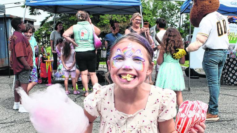 Aubrey Wilson of Hampton holds popcorn and cotton candy.