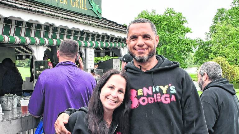 Heather and Ben Davey, the founders of Benny's Bodega, pose for a photo.