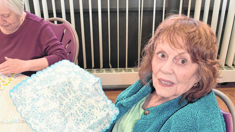 Eileen Ward of Newton holds a craft she's working.