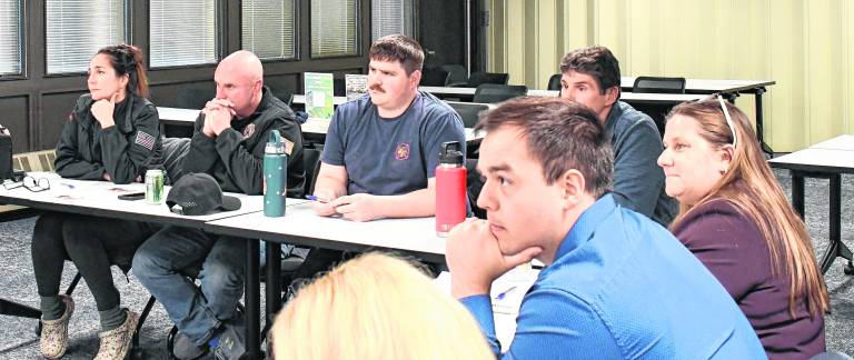 <b>First responders sit in a training class.</b>