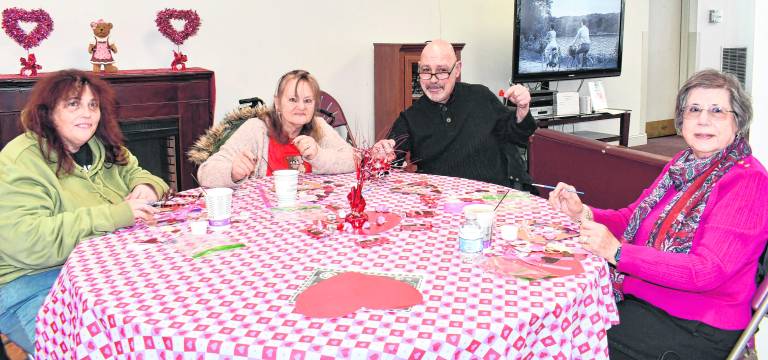 Leslie Coft, Robbin Lee, Angelo Vaz and Josephine Miragliotta, all from Newton, look up from their crafts.