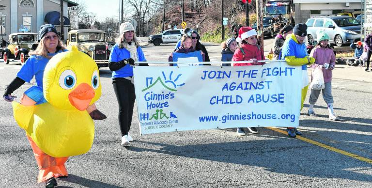 Represenatives of Ginnie’s House march in the parade.