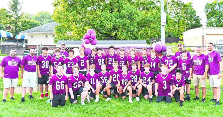 The eighth-grade football team poses for a photo.