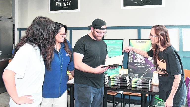 Sparta author Kelly Catlin points to a page in her book.