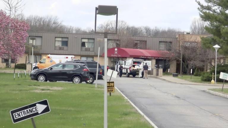 Ambulance crews are parked outside Andover Subacute and Rehabilitation Center in Andover on April 16, 2020. (AP Photo/Ted Shaffrey)