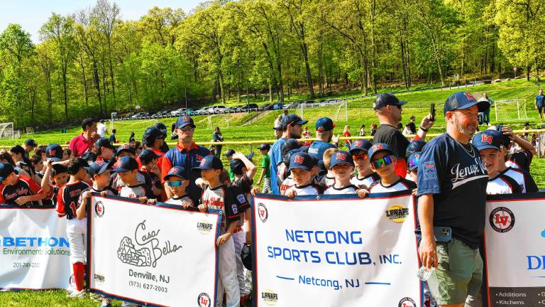Teams line up behind their sponsors’ banners on the Lenape Valley Little League’s opening day Saturday, May 3 at C.O. Johnson Park in Byram. (Photos by Maria Kovic)