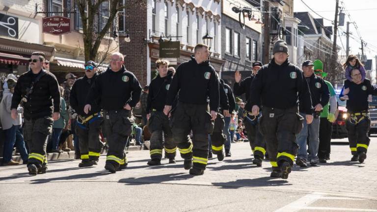 Members of the Newton Fire Department march in the St. Patrick’s Day Parade on March 18 in Newton. (Photos by John Hester)