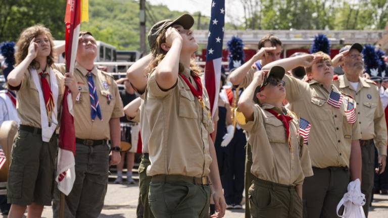 BP1 Members of Boy Scout Troop 276 salute the flag at the firehouse in Byram. . (Photo by John Hester)