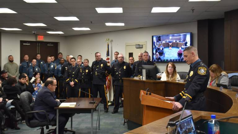 Joseph D’Annibale, right, at the podium, retired last week.