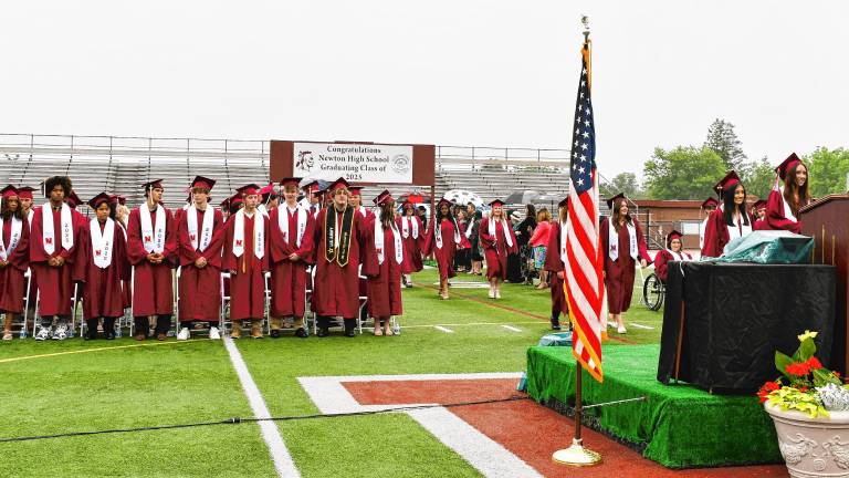 Members of the Newton High School Class of 2025 stand during graduation Monday, June 16. (Photo by Maria Kovic)