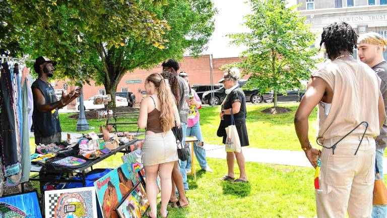 People shop at the fifth annual Juneteenth celebration, hosted by the H3AL Network, on June 21 at the Newton Green. (Photo by Maria Kovic)