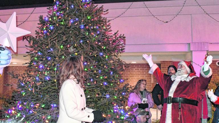 Santa Claus celebrates the lighting of the tree.