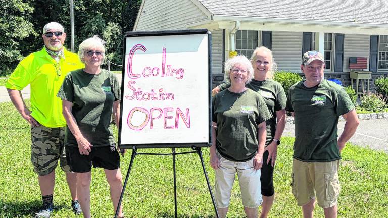 Members of Stillwater CERT stand outside a cooling station.