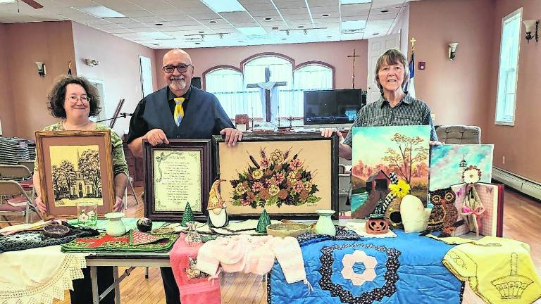 Some items that are to be sold at the 77th Lords Auction. Pictured, from left, Kathleen Heeney, Pastor Fred Laux and Charlene Cook.