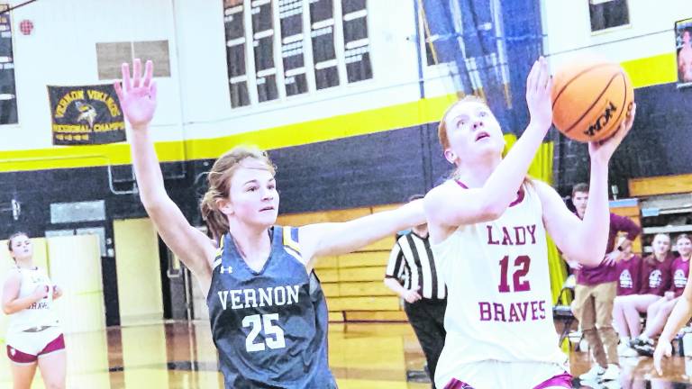 Newton's Avery Eigner leaps during a shot. Eigner scored 16 points.