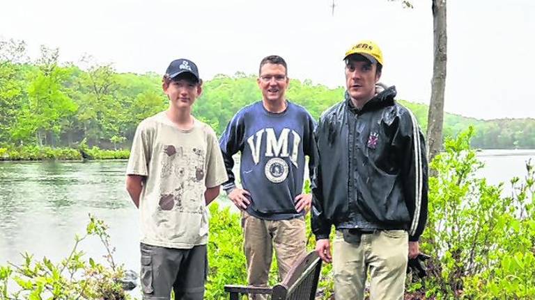 Life Scout Trey Hydock is shown with Assistant Scoutmasters Russ Raffay and James Braun in front of new bench with a view of Johnson Pond
