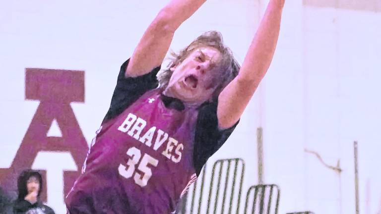 Newton's Anthony Romeo grabs the ball in the second period. Romeo scored 3 points.