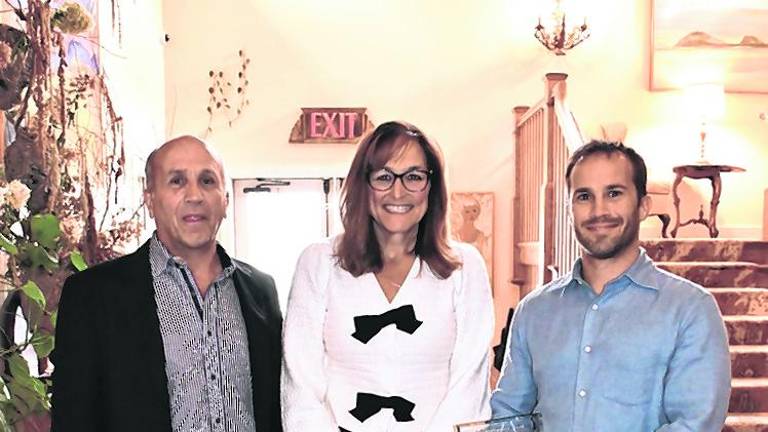 Anthony Berardi, County Commissioner Jill Space and Alex Berardi posing for me. Berardi Building Co., LLC, won the Redevelopment Award.